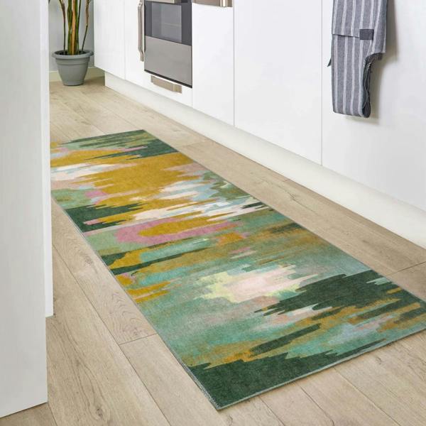 Colorful abstract patterned rug on a wooden floor in a kitchen setting.