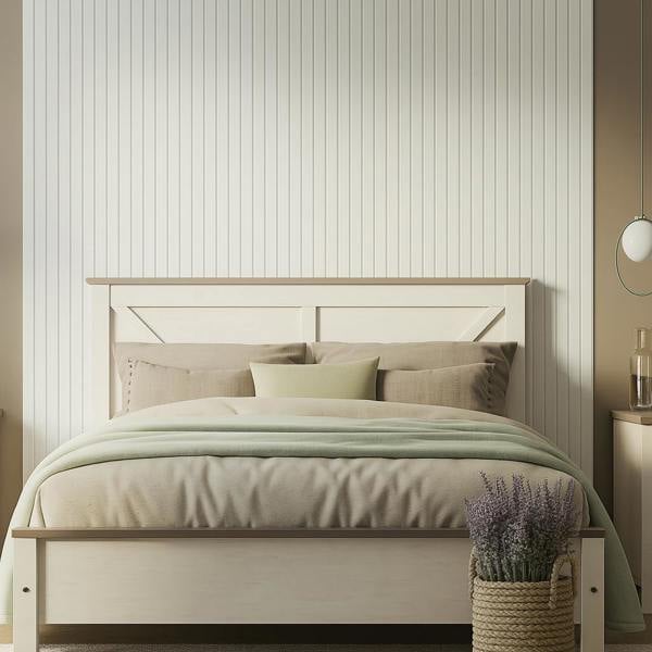 Neatly made bed with light bedding in a bedroom setting, with white slat wall panel feaure wall