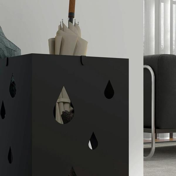 Black steel umbrella stand with cut-out raindrop design and umbrella storage