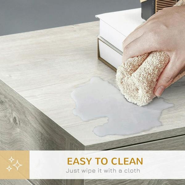 Grey end table top being wiped with a cloth; clean, flat tabletop surface.