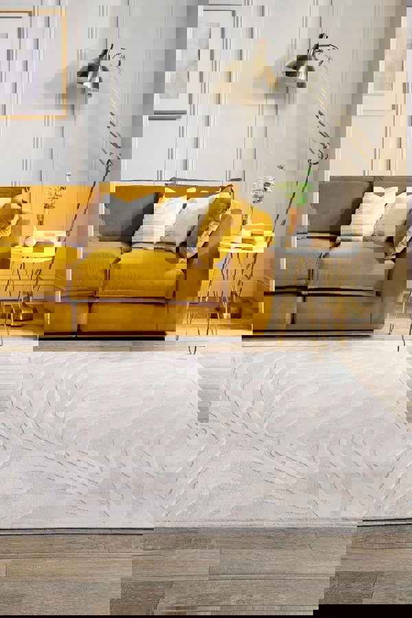 Modern abstract geometric rug in cream shades accenting a cozy living room with a yellow sofa.