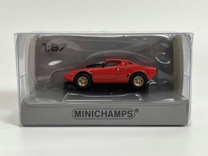 a red toy car in a plastic packaging
