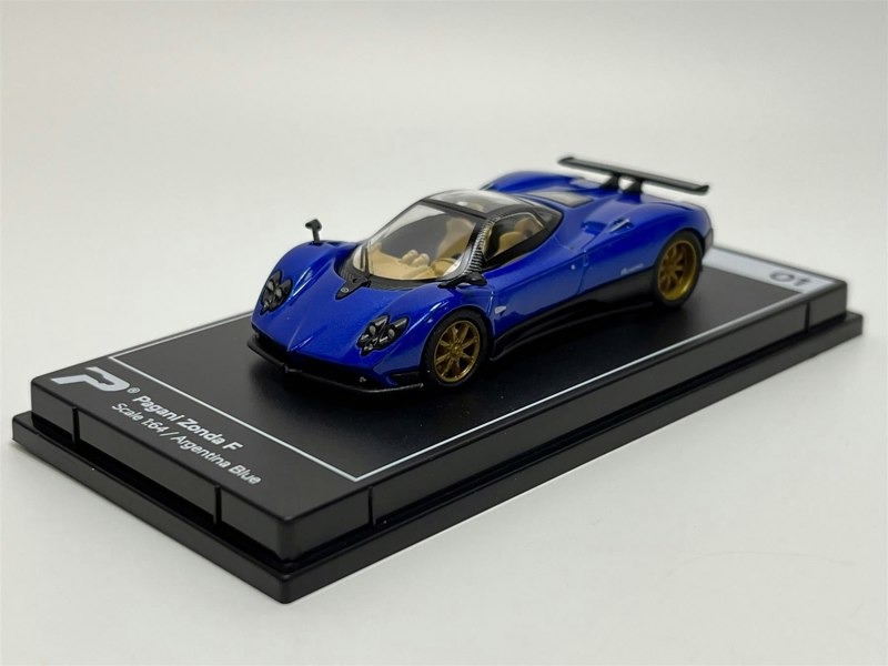 a blue toy car on a black rectangular surface