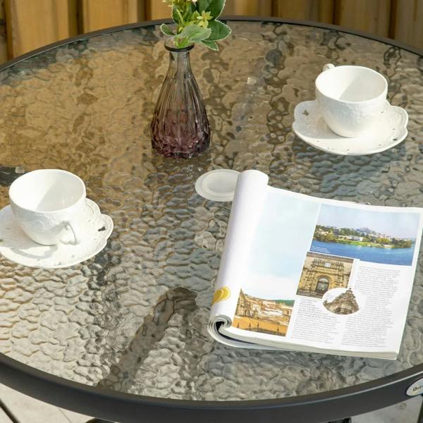 Black round bistro table with textured tempered glass top for outdoor dining