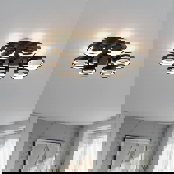 black large flush ceiling light installed in the large living room of a home 