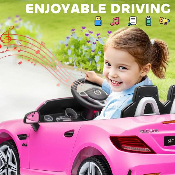 Pink kids electric ride-on car with steering wheel; child smiling and seated