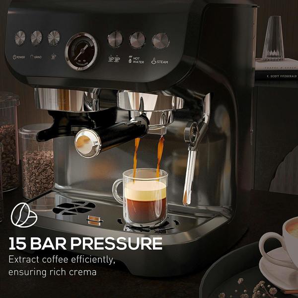 Black espresso machine dispensing coffee into cup with steam wand