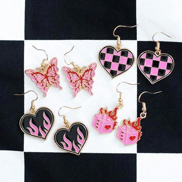 Assorted enamel earrings: pink butterflies, checkerboard hearts, and flame heart drops