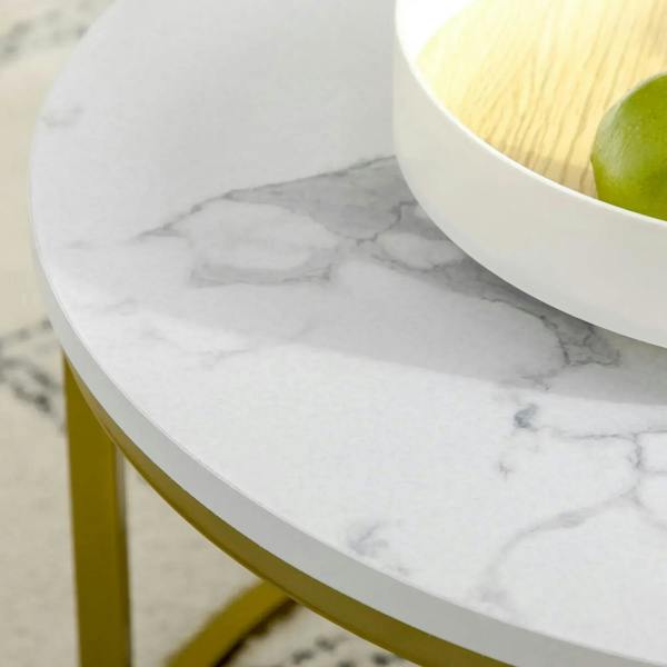 Close-up of white marble-look tabletop with gold metal frame edge
