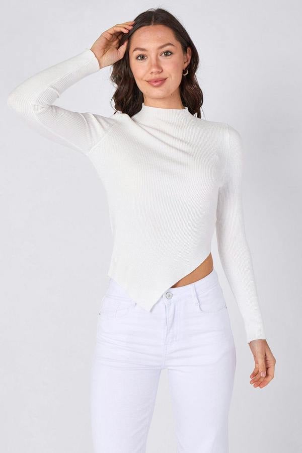 Woman wearing a white long-sleeve top and white pants on a white background