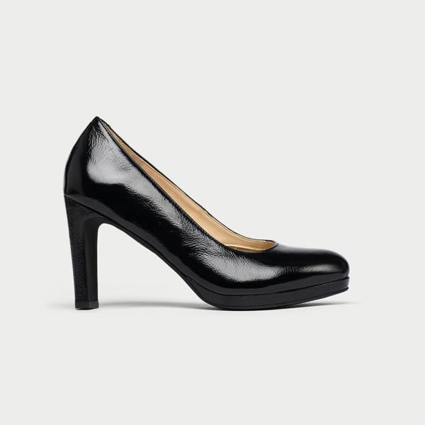 Black high-heeled shoe on a light gray background
