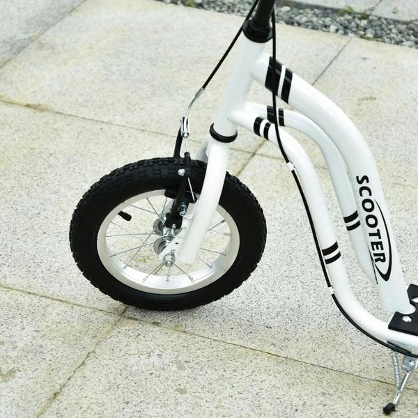 Front wheel and fork of white kick scooter with black inflatable tire on sidewalk