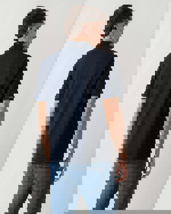 back shot of a model wearing an Aquascutum Mens Stretch Piquet Badge Polo Shirt in Navy 11