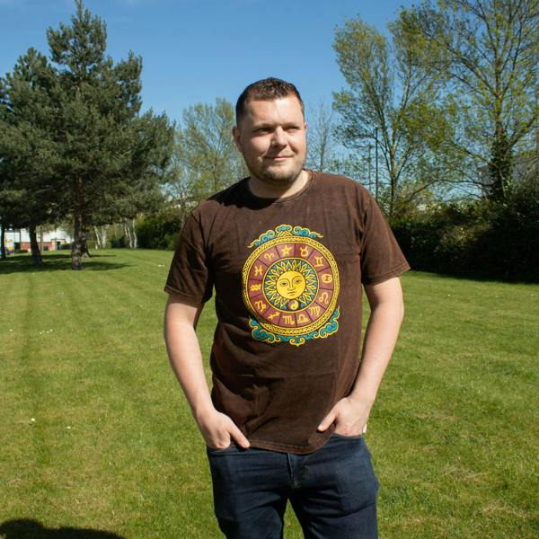 Brown stonewashed cotton T-shirt with sun zodiac graphic on chest, worn by model
