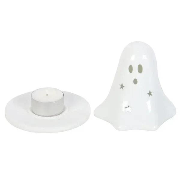 White ceramic ghost holder with round tealight dish and face cutouts