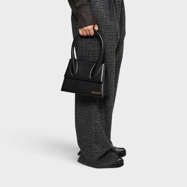 Supplied Fashion Jacquemus Le Grand Chiquito black structured handbag with silver hardware held by a model