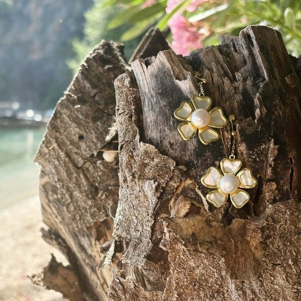 Luxury floral drop earrings with freshwater pearl and mother-of-pearl in gold vermeil on the beach.