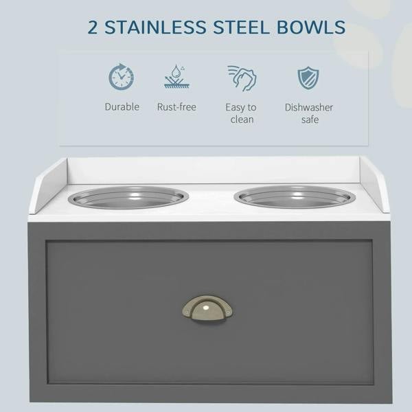 Grey raised dog feeding station with two stainless steel bowls and front storage drawer.