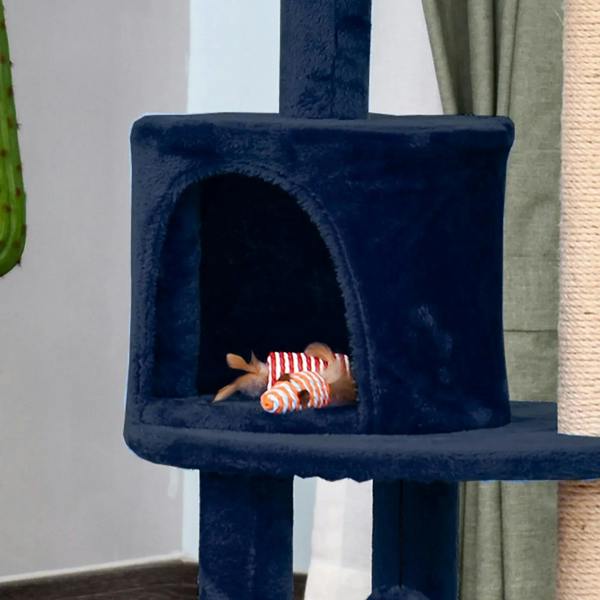 Blue plush cubby cat bed with a striped toy fish inside
