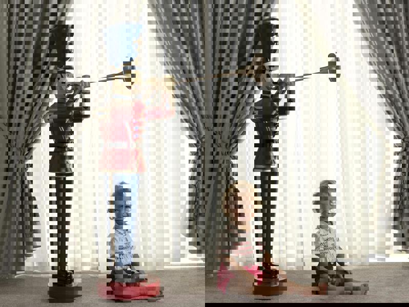 Boy wearing red smocked, short sleeved shirt and matching red button on short set