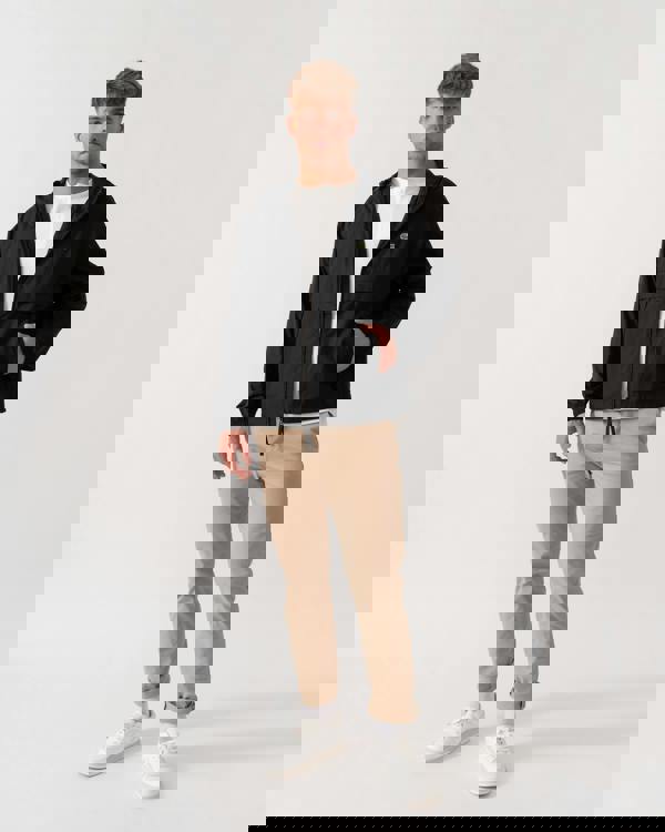 Model wearing Lacoste Lightweight Packable Water-Repellent Ripstop Jacket in Black 031 - Full Length