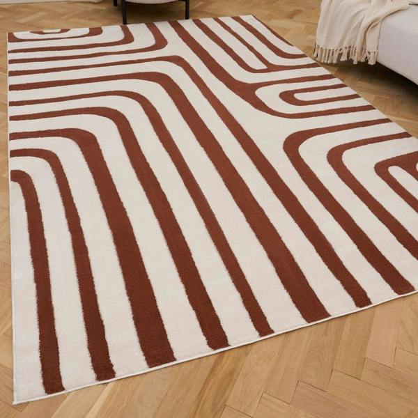 Rug with brown and beige wavy pattern on a wooden floor