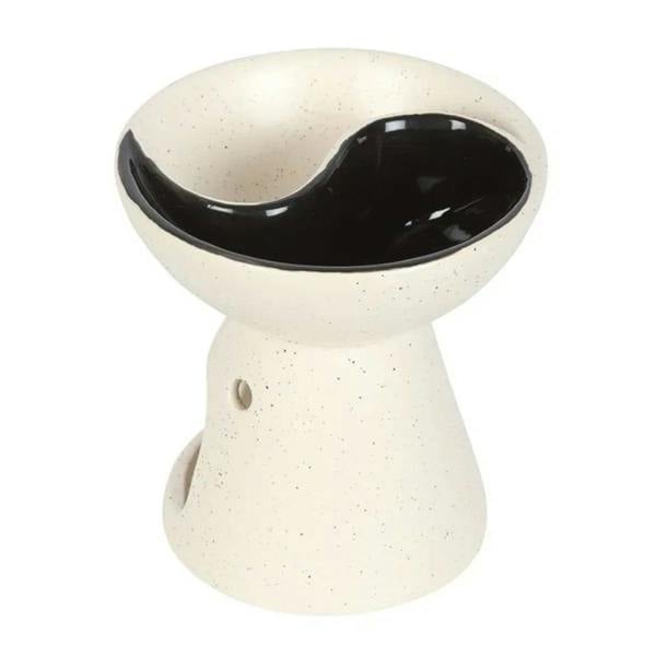 Ceramic yin-yang oil burner with speckled white exterior and black glazed top dish; no flame