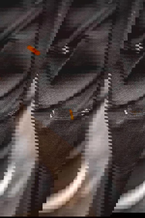 WorkTough Mens Cargo Stretch Fit Cordura Work Trouser Fleece Jogger, close-up of black fabric with orange stitching details.