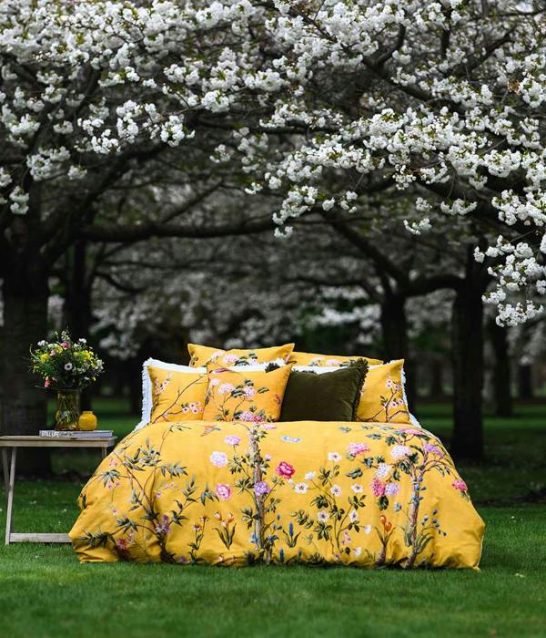 Opulent and artistic, M.M Linen Yuki design of charming blossoms and fauna on a sunny and soft, golden background