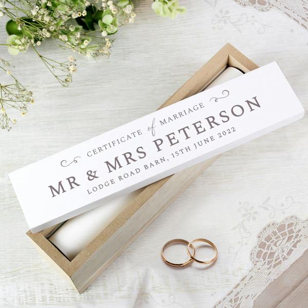 A wooden certificate keepsake box showing a custom print variant using the happy couple's first names and church venue details.