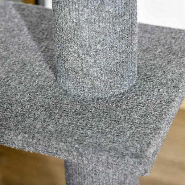 Grey carpeted cat tree platform close-up with central vertical post and edge cut