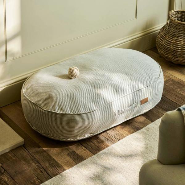 Extra large oval sage green striped dog cushion with a side carry handle.