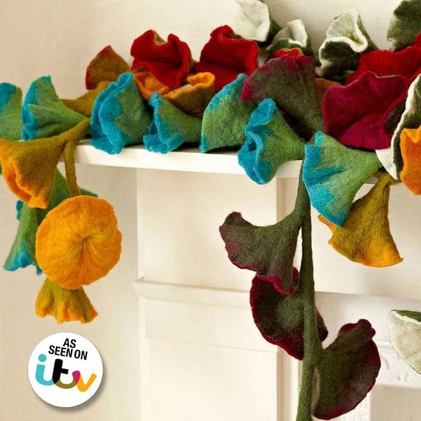 A Felt Flower Garland draped over a mantle.