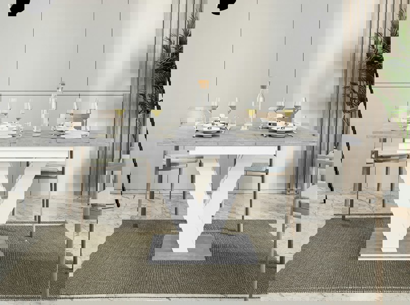 Compact extendable dining table with grey concrete top and white stand.