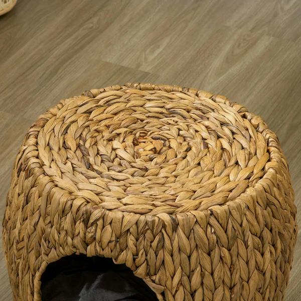 Top view of a round woven wicker cat bed house in natural tan color