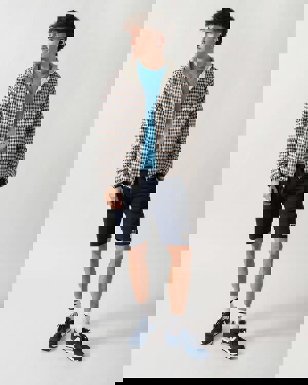 full length shot of a model wearing an Aquascutum Mens RLG Badge Reversible Sailor Jacket in Salvia 34 showing reversed check pattern