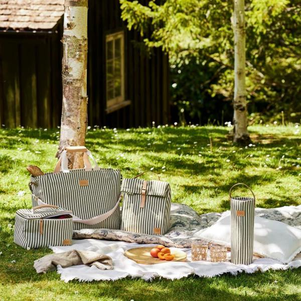 A collection of moss green striped picnic bags, bottle coolers, and blankets.
