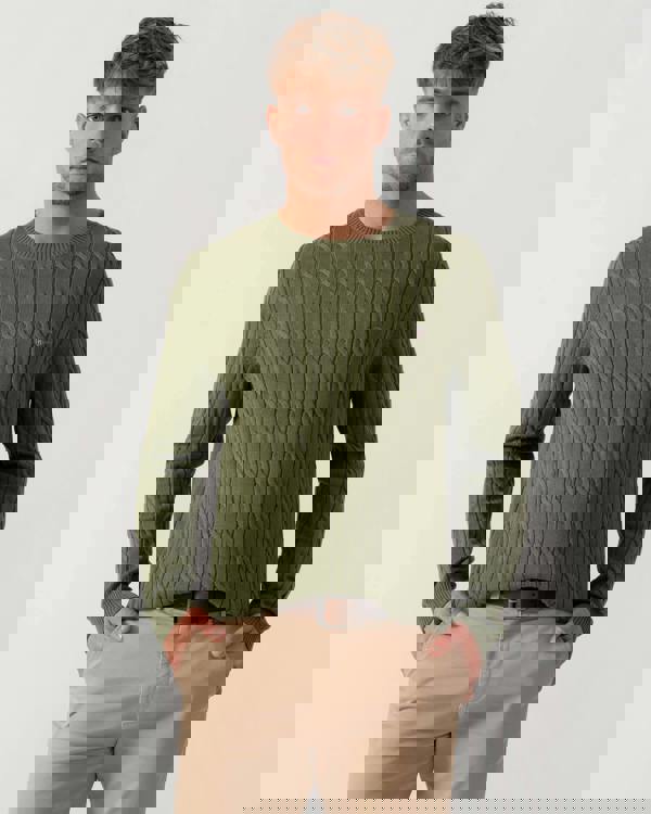 Model wearing GANT Mens Cotton Cable Knit Crew Neck Jumper in 379 Dry Herb Green - Main