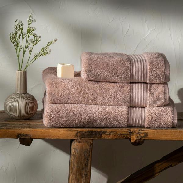 Soft Pink Egyptian Cotton Towels styled in a bedroom | Soak and Sleep