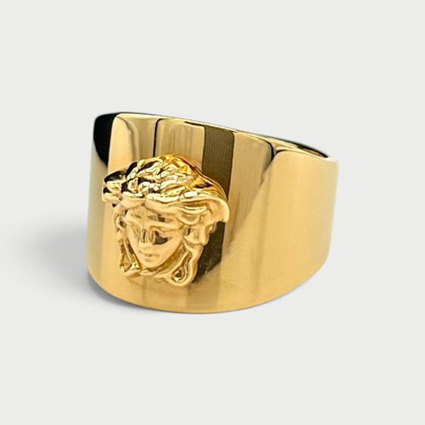 Supplied Fashion gold statement ring featuring a polished band and a detailed Medusa head motif.