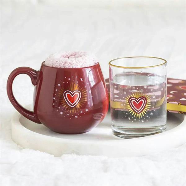 Red fuzzy-rim mug and clear glass tumbler with heart-and-star decorations.