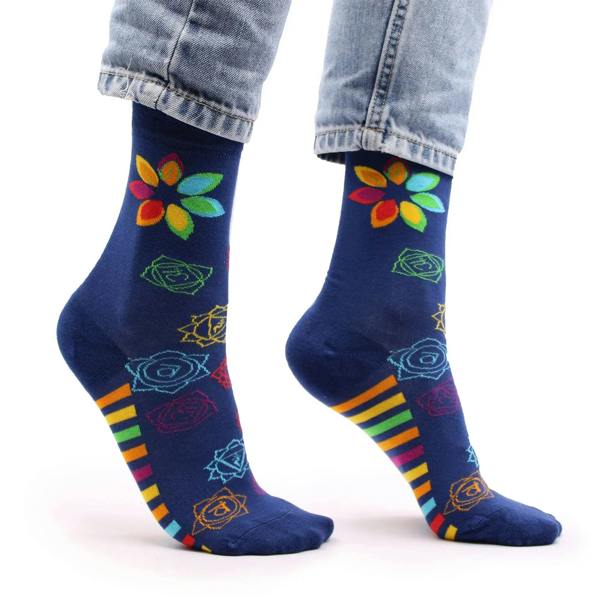 Dark blue bamboo socks with flower chakra symbols and rainbow-striped band near toe