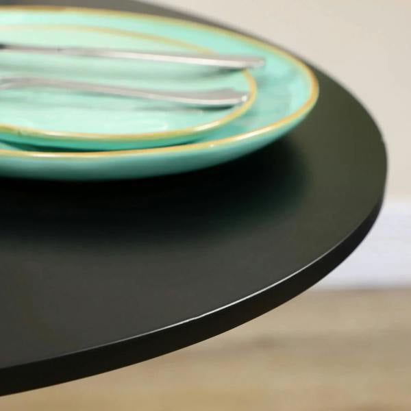 Black round tabletop edge with smooth curved rim and partial plate on top