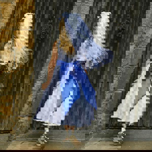 girl in a white flower girl dress showing the detail on the back