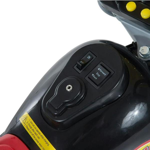 Black battery and power control panel with switch buttons on ride-on motorbike trike