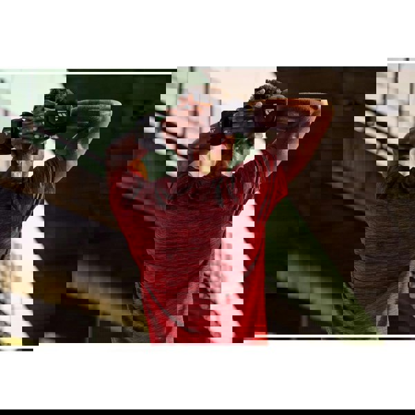 Person in red shirt using adidas 1.5kg ankle weights