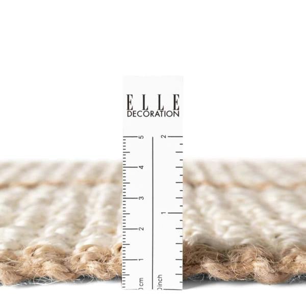 Textured beige rug with vertical stripes on a white background