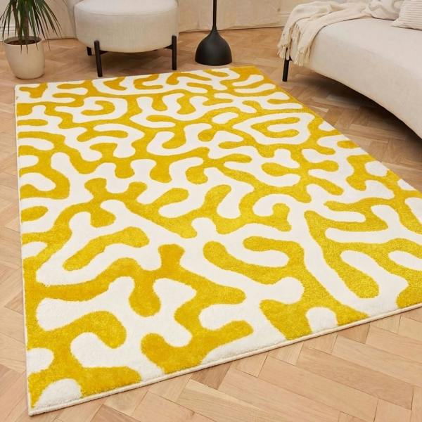 Yellow and white patterned rug on a wooden floor