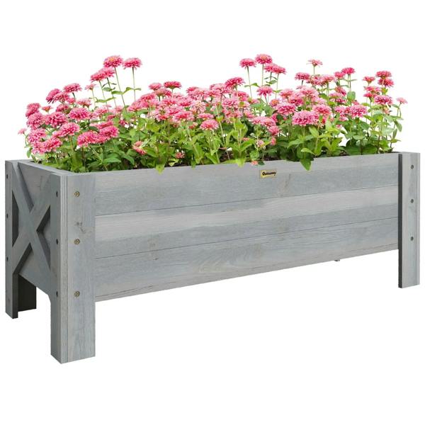 Grey raised garden planter box with pink flowers growing inside