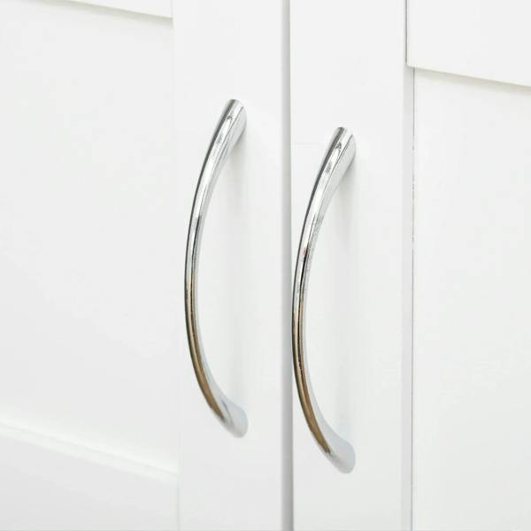 Chrome curved handles on white cabinet doors of a rolling kitchen trolley